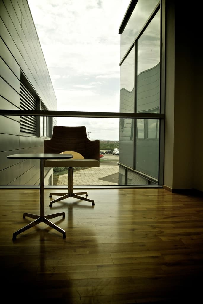 Modern commercial lobby with polished floors and a full-height glass wall