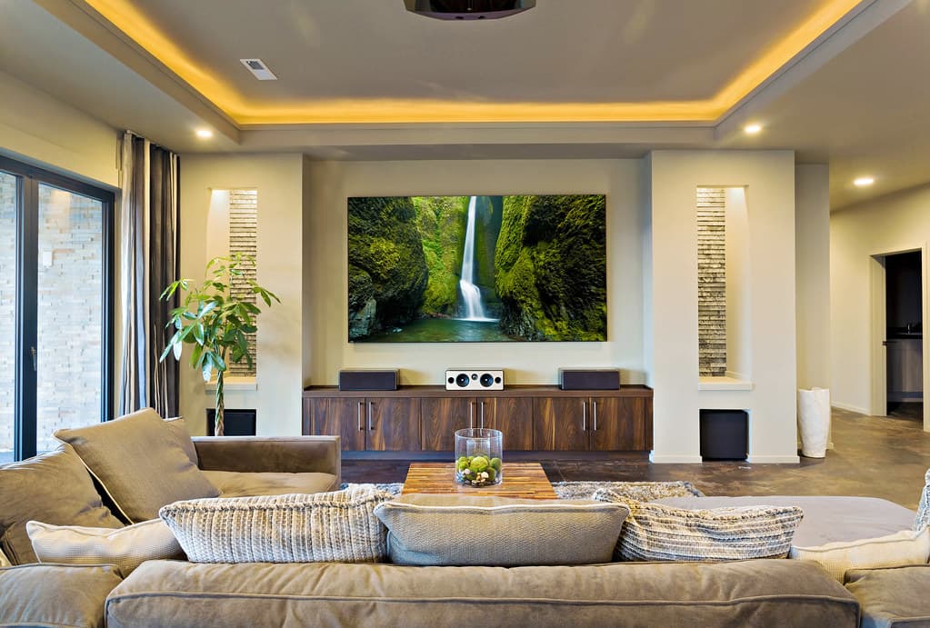 Warm, immaculate open-plan living room with a sectional sofa and wood cabinetry