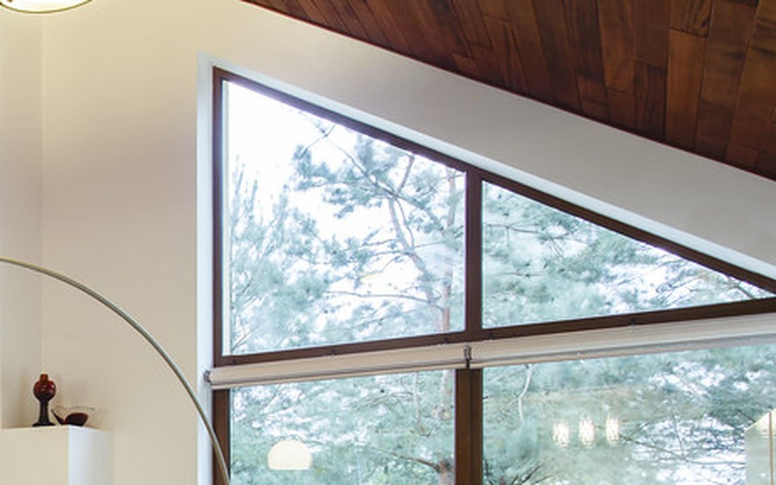 Open-plan interior filled with daylight through large clean windows